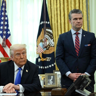 (FILES) US President Donald Trump and Secretary of Defense Pete Hegseth listen during an event in the Oval Office of the White House in Washington, DC, on March 21, 2025. A US journalist was inadvertently included in a group chat in which Defense Secretary Pete Hegseth, Vice President JD Vance and other top officials discussed upcoming strikes against Yemen's Huthi rebels, the White House confirmed on March 24, 2025. (Photo by Annabelle Gordon / AFP)