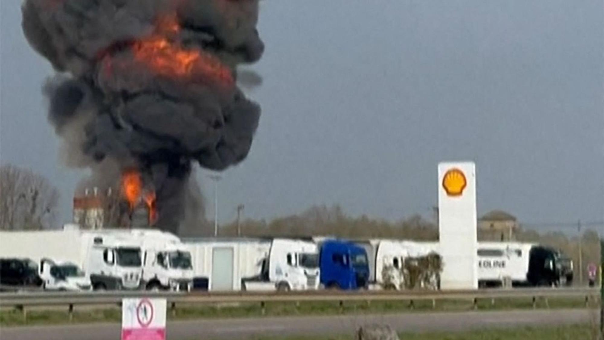 This image grabbed from a video shows a ball of fire as a plane crashes, and two persons parachuting after ejecting (Top) following a collision between two Alpha Jet aircrafts from the "Patrouille de France," the national air display team, in eastern France, near Air Base 113 in Saint-Dizier, eastern France, on March 25, 2025. An accident involving two Alpha Jets of the Patrouille de France occurred on March 25 in the afternoon near Saint-Dizier, eastern France, the French Minister of the Armed Forces announced on X, and three people, both pilots and a passenger were "found conscious", the French Air Force told AFP. (Photo by Caroline THOMASSIN / AFP)