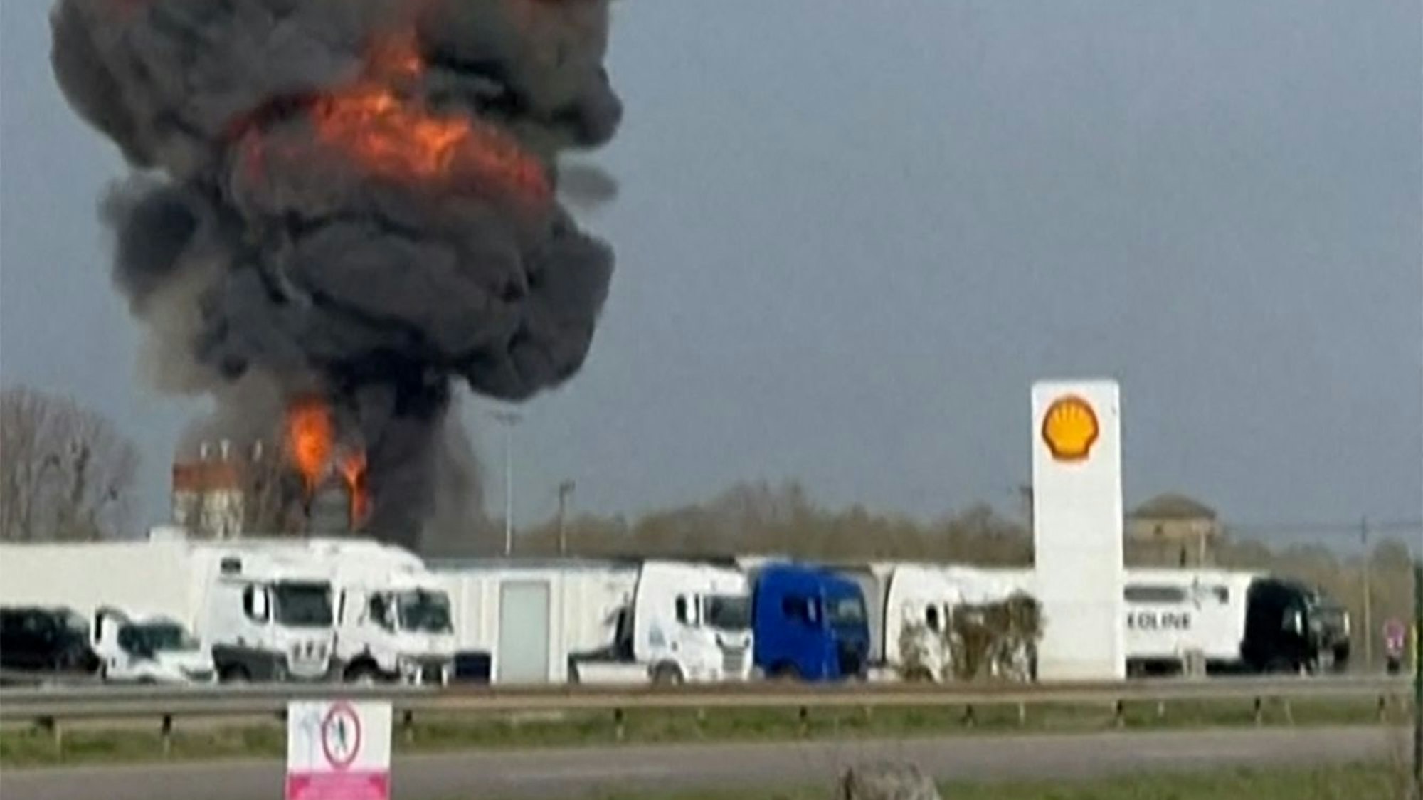 This image grabbed from a video shows a ball of fire as a plane crashes, and two persons parachuting after ejecting (Top) following a collision between two Alpha Jet aircrafts from the "Patrouille de France," the national air display team, in eastern France, near Air Base 113 in Saint-Dizier, eastern France, on March 25, 2025. An accident involving two Alpha Jets of the Patrouille de France occurred on March 25 in the afternoon near Saint-Dizier, eastern France, the French Minister of the Armed Forces announced on X, and three people, both pilots and a passenger were "found conscious", the French Air Force told AFP. (Photo by Caroline THOMASSIN / AFP)