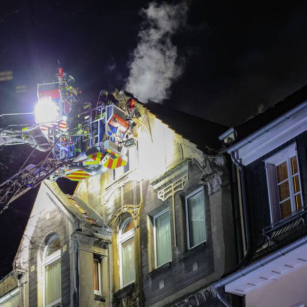 27.03.2025, Nordrhein-Westfalen, Leverkusen: Feuerwehrleute arbeiten mit zwei Drehleitern an einem Brand. Bei einem Wohnungsbrand in Leverkusen sind Menschen ums Leben gekommen. Vor Ort stellten die Feuerwehr dichten Rauch im dritten Obergeschoss des Hauses fest. Foto: Gianni Gattus/dpa +++ dpa-Bildfunk +++