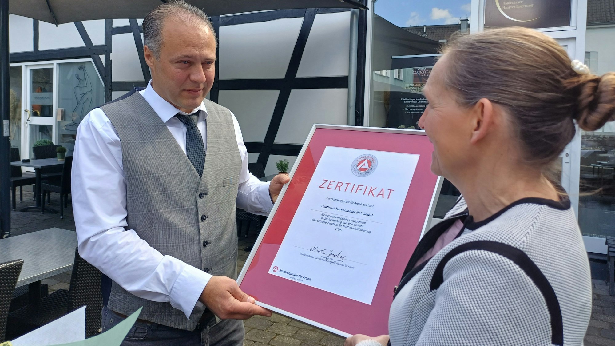 Nicole Jordy (r.) von der Agentur für Arbeit überreicht Geschäftsführer Kresimir Kozina stellvertretend für das ganze Unternehmen das Zertifikat.