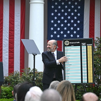 US President Donald Trump delivers remarks on reciprocal tariffs as US Secretary of Commerce Howard Lutnick holds a chart during an event in the Rose Garden entitled "Make America Wealthy Again" at the White House in Washington, DC, on April 2, 2025. Trump geared up to unveil sweeping new "Liberation Day" tariffs in a move that threatens to ignite a devastating global trade war. Key US trading partners including the European Union and Britain said they were preparing their responses to Trump's escalation, as nervous markets fell in Europe and America. (Photo by Brendan SMIALOWSKI / AFP)