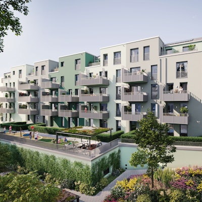 Mehrere Häuser mit Balkonen sind über einen grünen Innenhof mit Spielplätzen und Bepflanzungen aus zu sehen.
