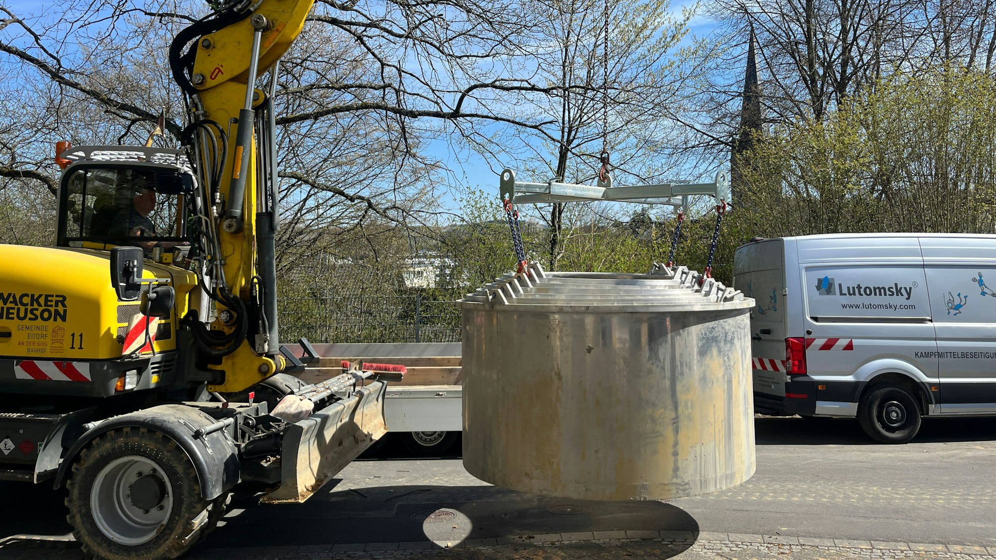 Schachtelemente werden zu der Grube gebracht, um Arbeiter und Kampfmittelbeseitiger vor nachrutschender Erde zu schützen.