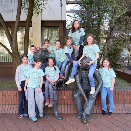 Auf dem Bild sind Kinder des Horts vor dem Rathaus zu sehen.