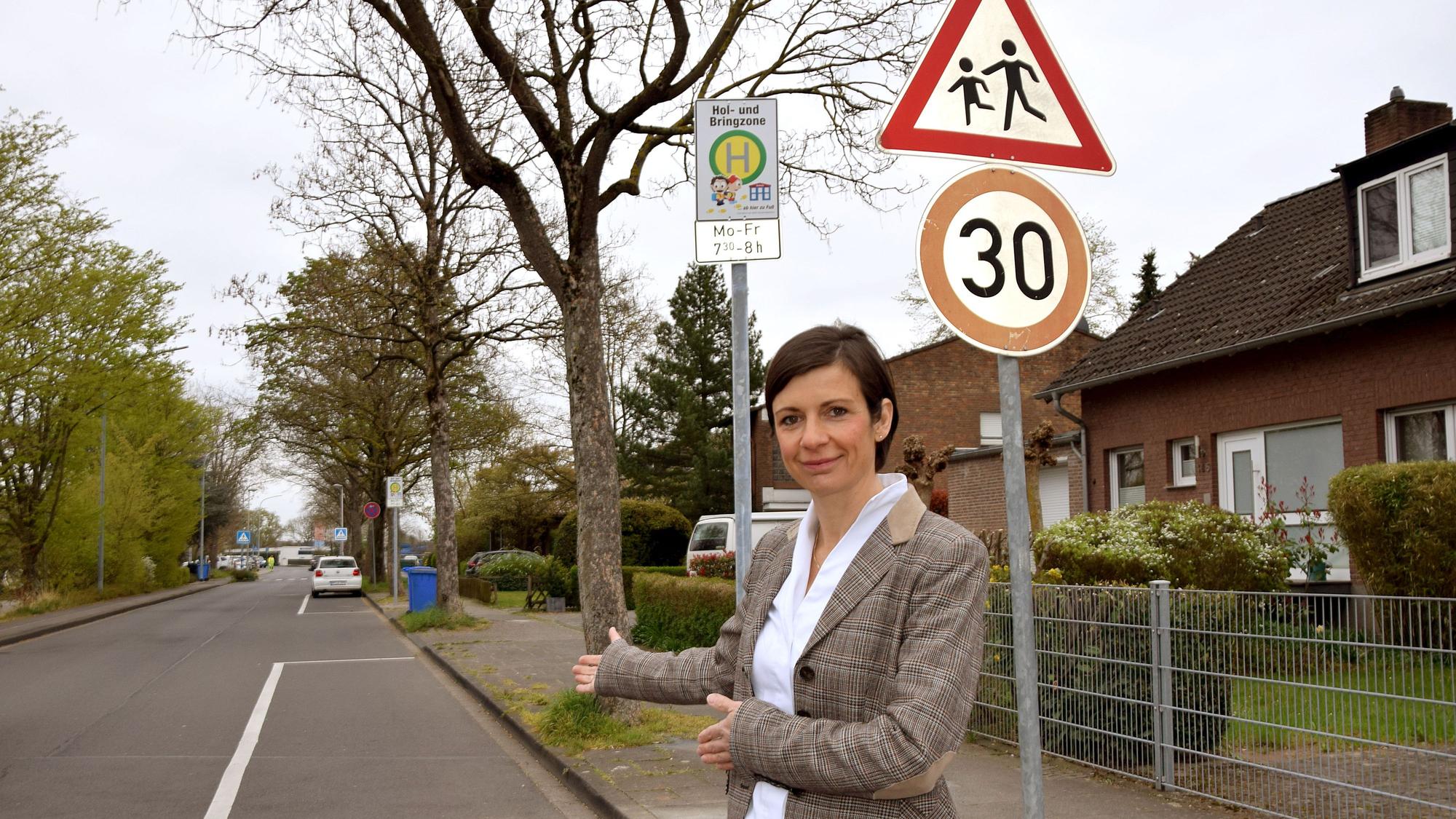 Eine Frau steht vor einer eingezeichneten Parkfläche.