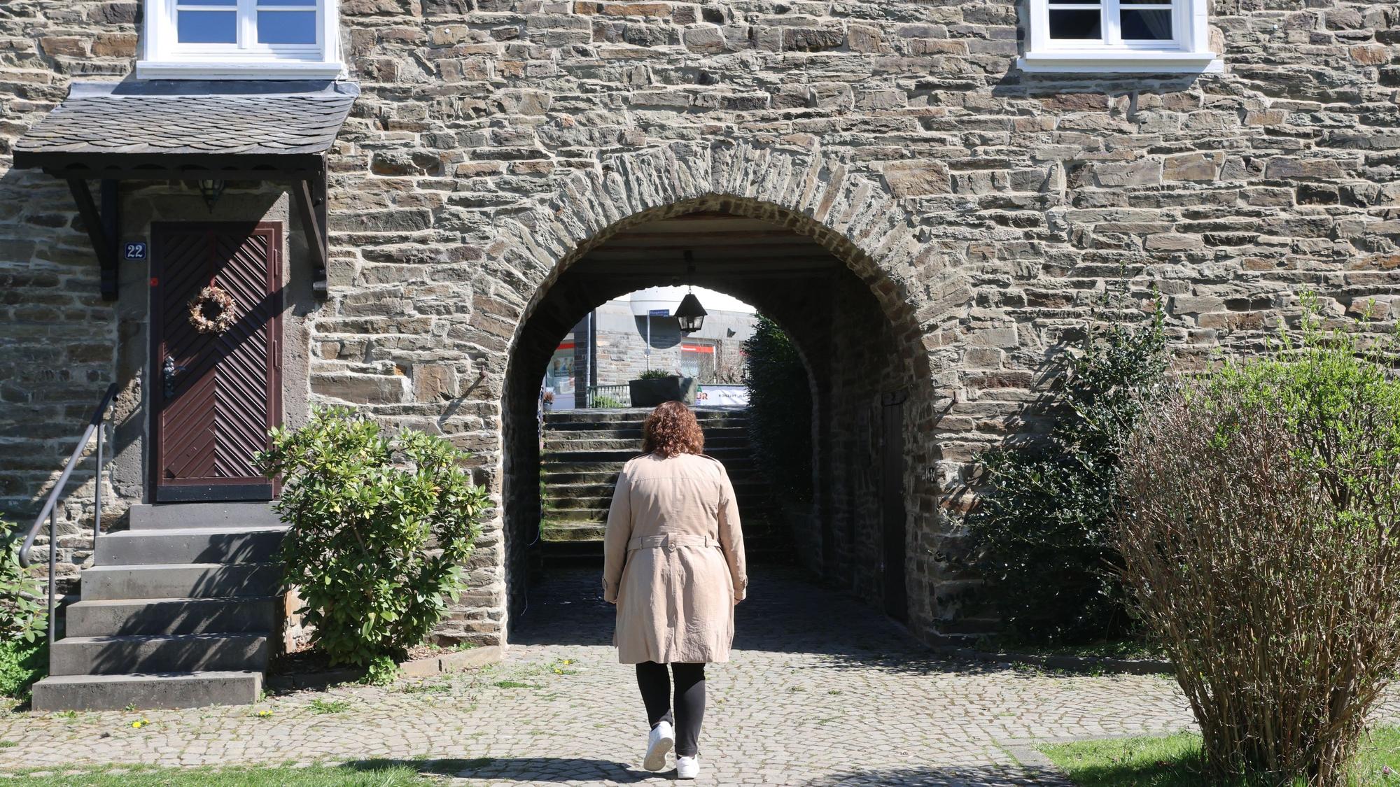 Eine Frau läuft durch den Burghof im Denklinger Ortskern.