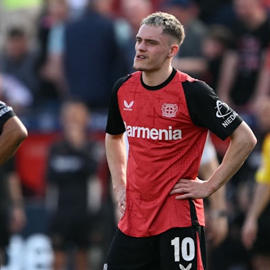 Bayer Leverkusen's French forward #21 Amine Adli (L) and Bayer Leverkusen's German midfielder #10 Florian Wirtz react after the German first division Bundesliga football match between Bayer Leverkusen and Union Berlin in Leverkusen, western Germany, on April 12, 2025. (Photo by INA FASSBENDER / AFP) / DFL REGULATIONS PROHIBIT ANY USE OF PHOTOGRAPHS AS IMAGE SEQUENCES AND/OR QUASI-VIDEO