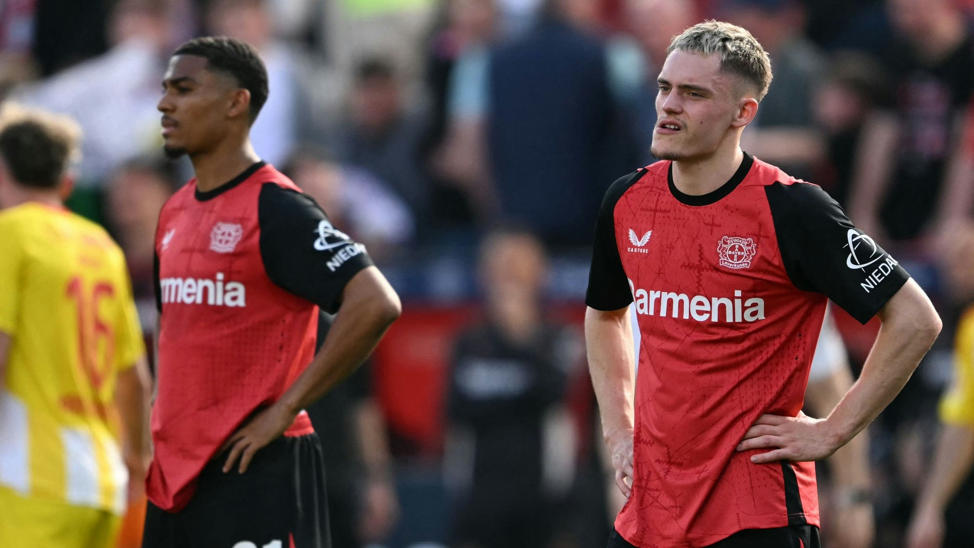 Bayer Leverkusen's French forward #21 Amine Adli (L) and Bayer Leverkusen's German midfielder #10 Florian Wirtz react after the German first division Bundesliga football match between Bayer Leverkusen and Union Berlin in Leverkusen, western Germany, on April 12, 2025. (Photo by INA FASSBENDER / AFP) / DFL REGULATIONS PROHIBIT ANY USE OF PHOTOGRAPHS AS IMAGE SEQUENCES AND/OR QUASI-VIDEO