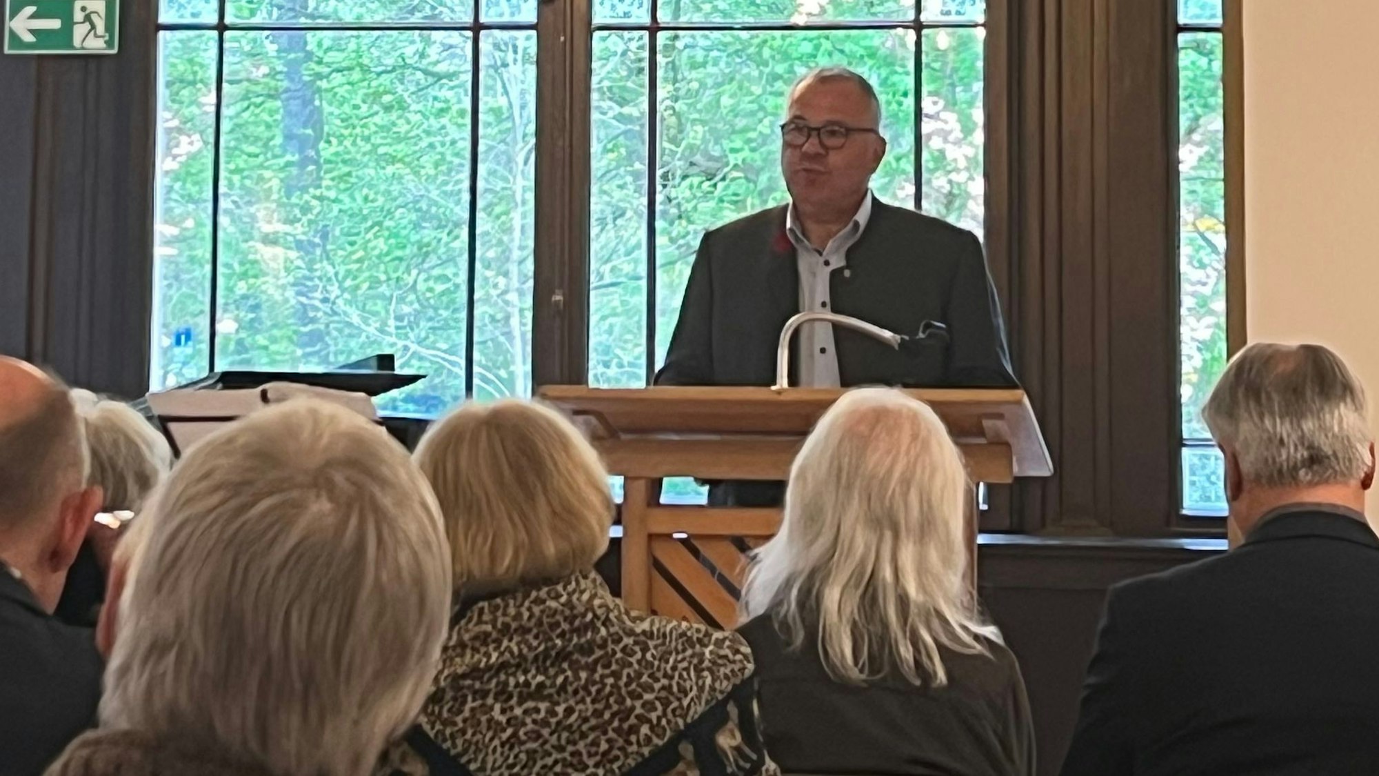 Ein Mann steht an einem Pult und hält eine Rede.