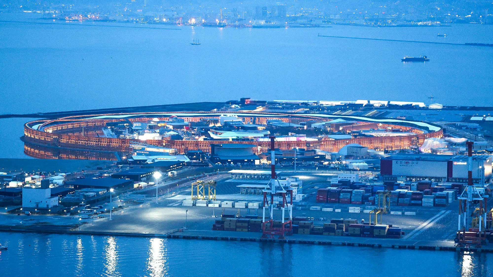 This overview image shows the "Grand Ring", made of wood, lit up at dusk on the eve of the opening of the 2025 Osaka Expo in Osaka on April 12, 2025. (Photo by JIJI PRESS / AFP) / Japan OUT