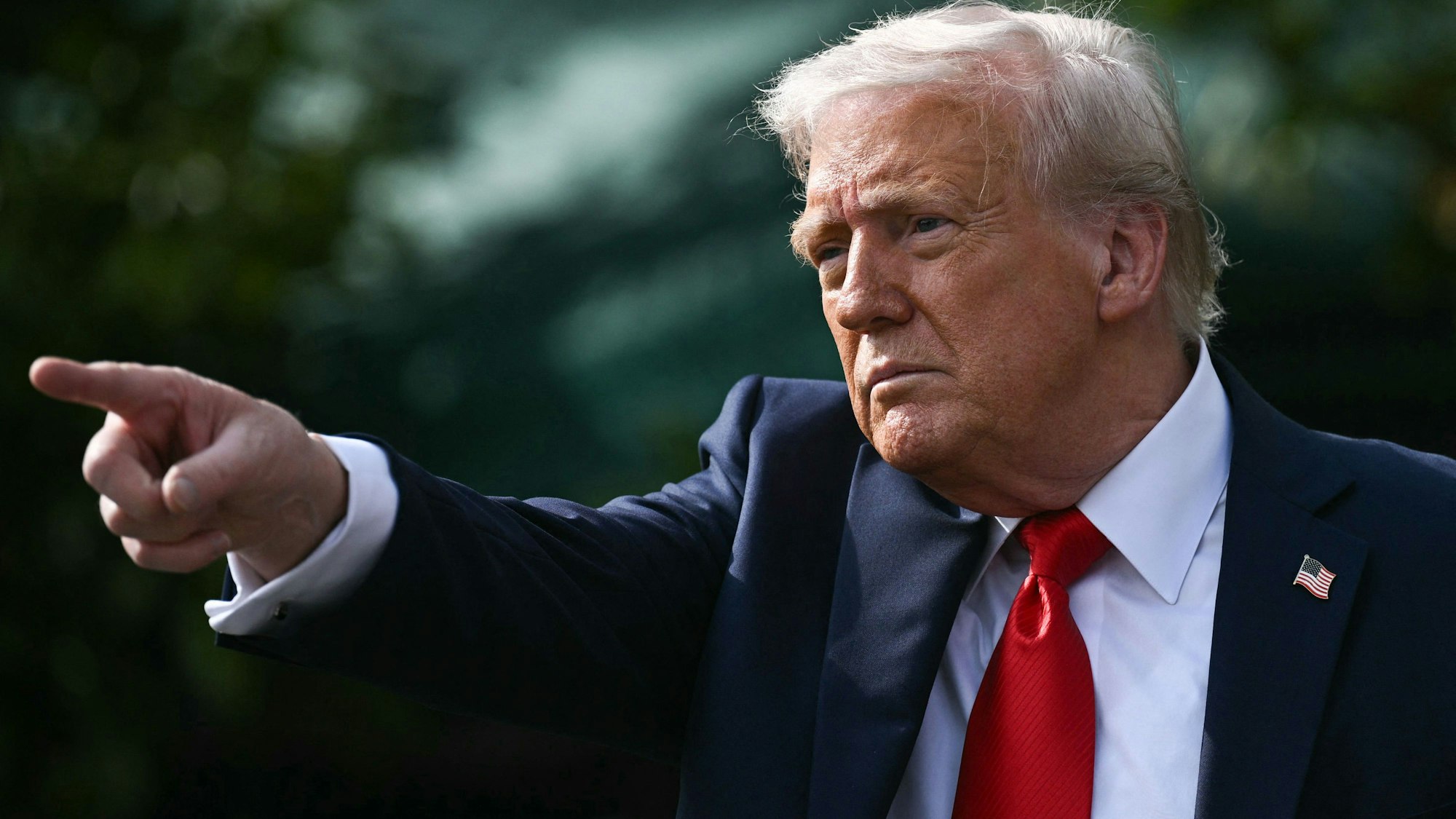 US President Donald Trump gestures after hosting the 2025 College Football National Champions, Ohio State Buckeyes, celebrating the team's title-winning season with a ceremony on the South Lawn of the White House in Washington, DC, April 14, 2025. (Photo by Brendan SMIALOWSKI / AFP) / ALTERNATE CROP