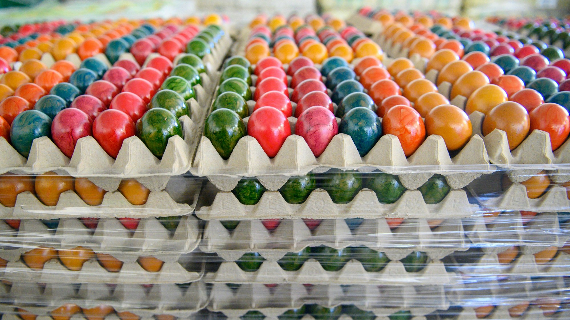 Farbige Ostereier lagern in einem Geflügelhof.