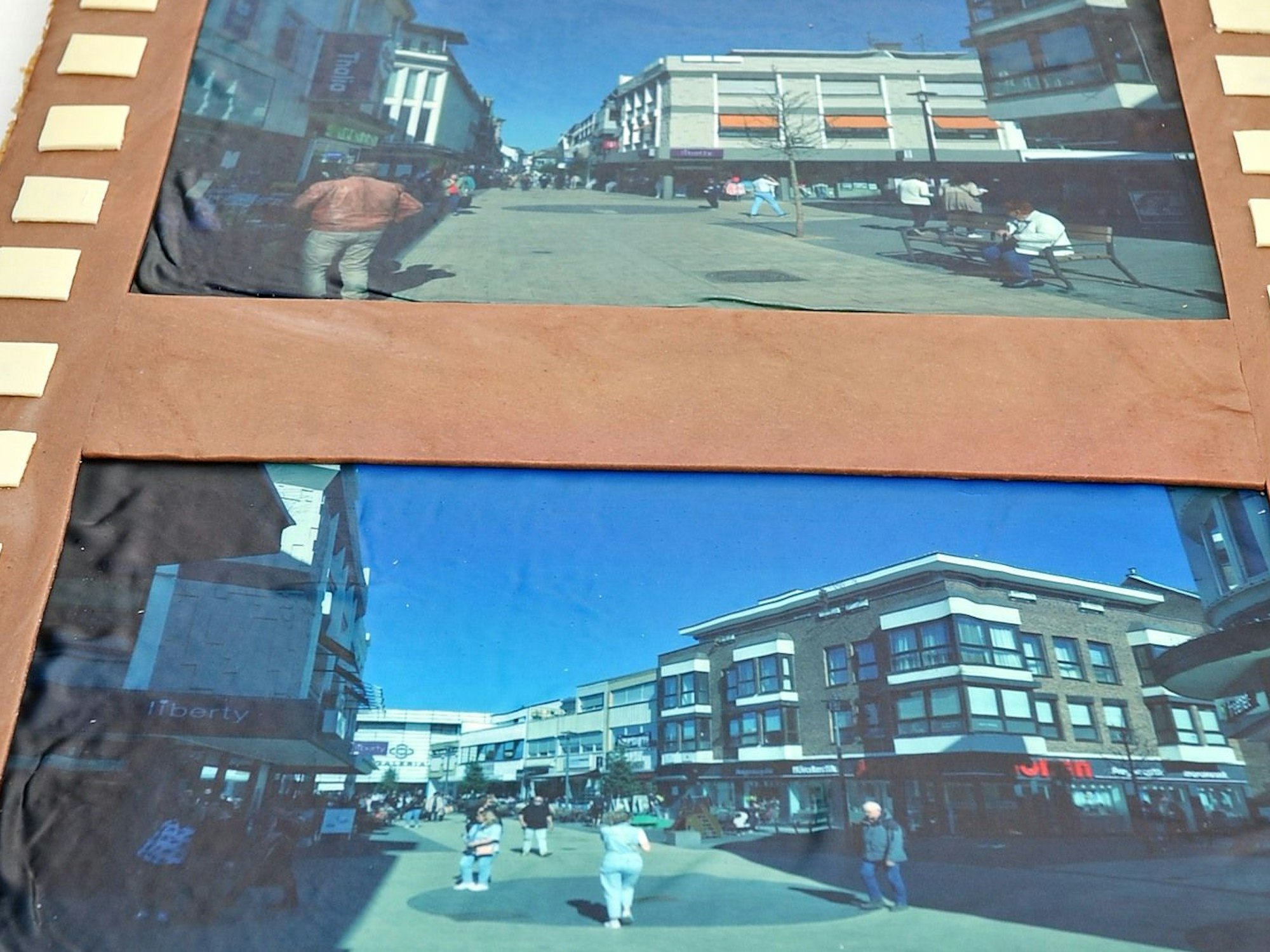 Auf dem Kuchen befinden sich Abbildungen, die die Innenstadt in den vergangenen Jahren zeigen.