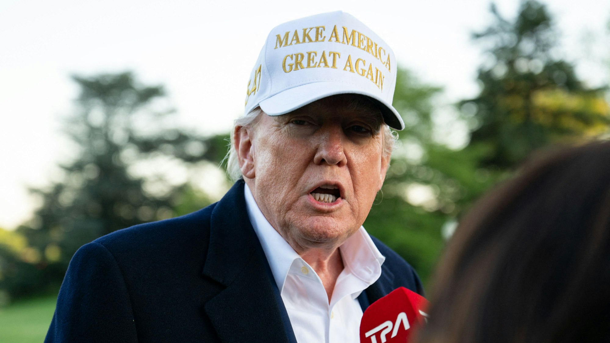 US President Donald Trump speaks to the press after arriving on the South Lawn of the White House in Washington, DC, on April 27, 2025. Trump is returning to Washington after attending the funeral of Pope Francis and spending part of the weekend at his Bedminster resort. (Photo by Annabelle GORDON / AFP)