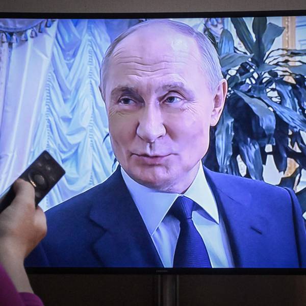 A woman watches a documentary on Russian President Vladimir Putin released on Russian state TV in Moscow on May 4, 2025. (Photo by Alexander NEMENOV / AFP)