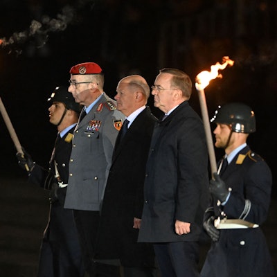 German Chancellor Olaf Scholz (C) flanked by German Defence Minister Boris Pistorius (R) and the General of the German Armed Forces Bundeswehr Carsten Breuer (R) arrive at the Defence Ministry to attend the Grand Tattoo (Grosser Zapfenstreich), a ceremonial send-off for outgoing German Chancellor in Berlin on May 5, 2025. (Photo by RALF HIRSCHBERGER / AFP)