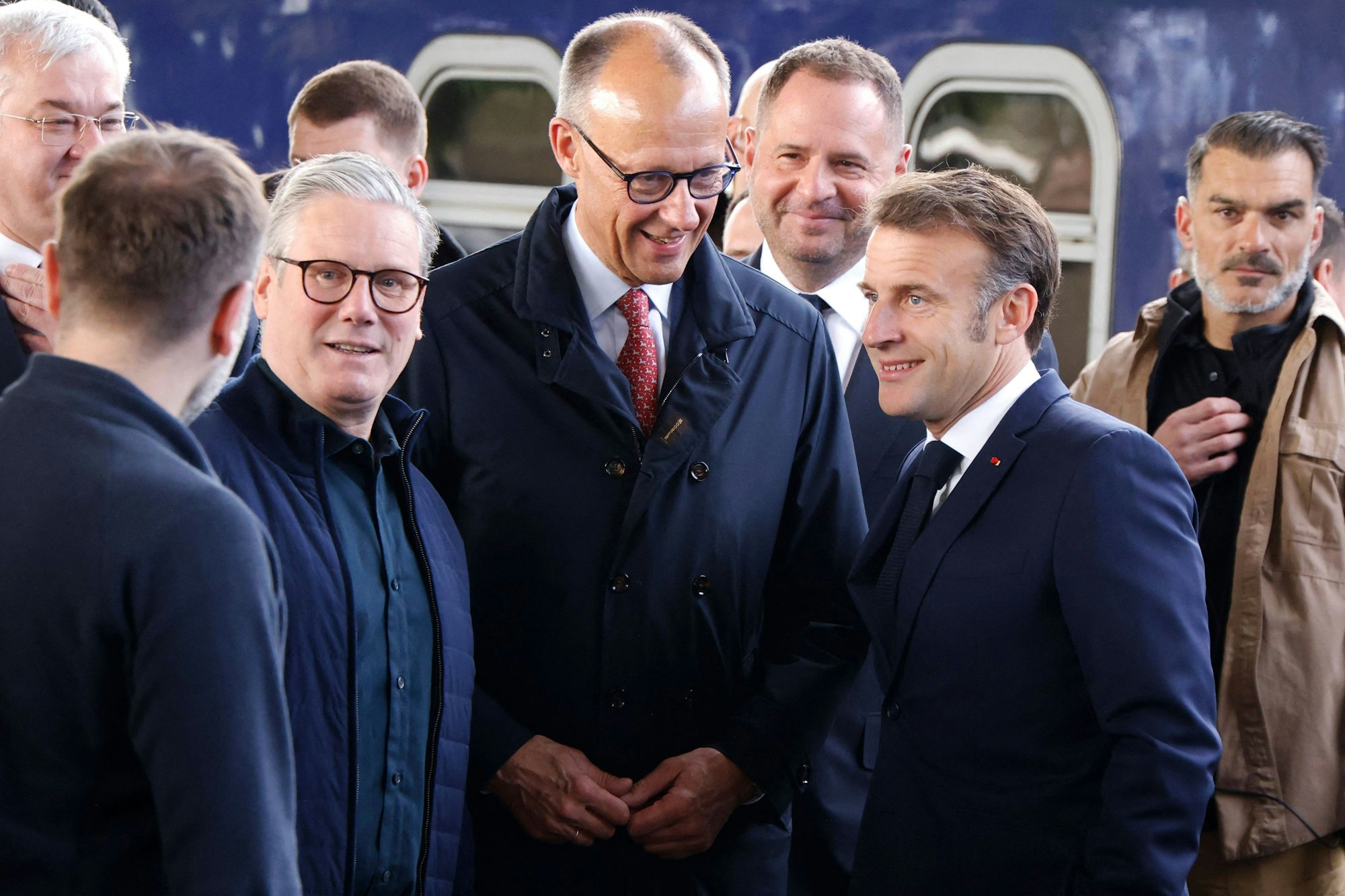 France's President Emmanuel Macron (R), Britain's Prime Minister Keir Starmer (L) and Germany's Chancellor Friedrich Merz (C) arrive at Kyiv railway station on May 10, 2025, ahead of a gathering of European leaders in the Ukranian capital. The leaders of Britain, France, Germany and Poland make an unprecedented joint visit to Kyiv on May 10, 2025 for talks with Ukraine's President Volodymyr and to urge Russia to agree a ceasefire, a joint statement said. (Photo by Ludovic MARIN / POOL / AFP)