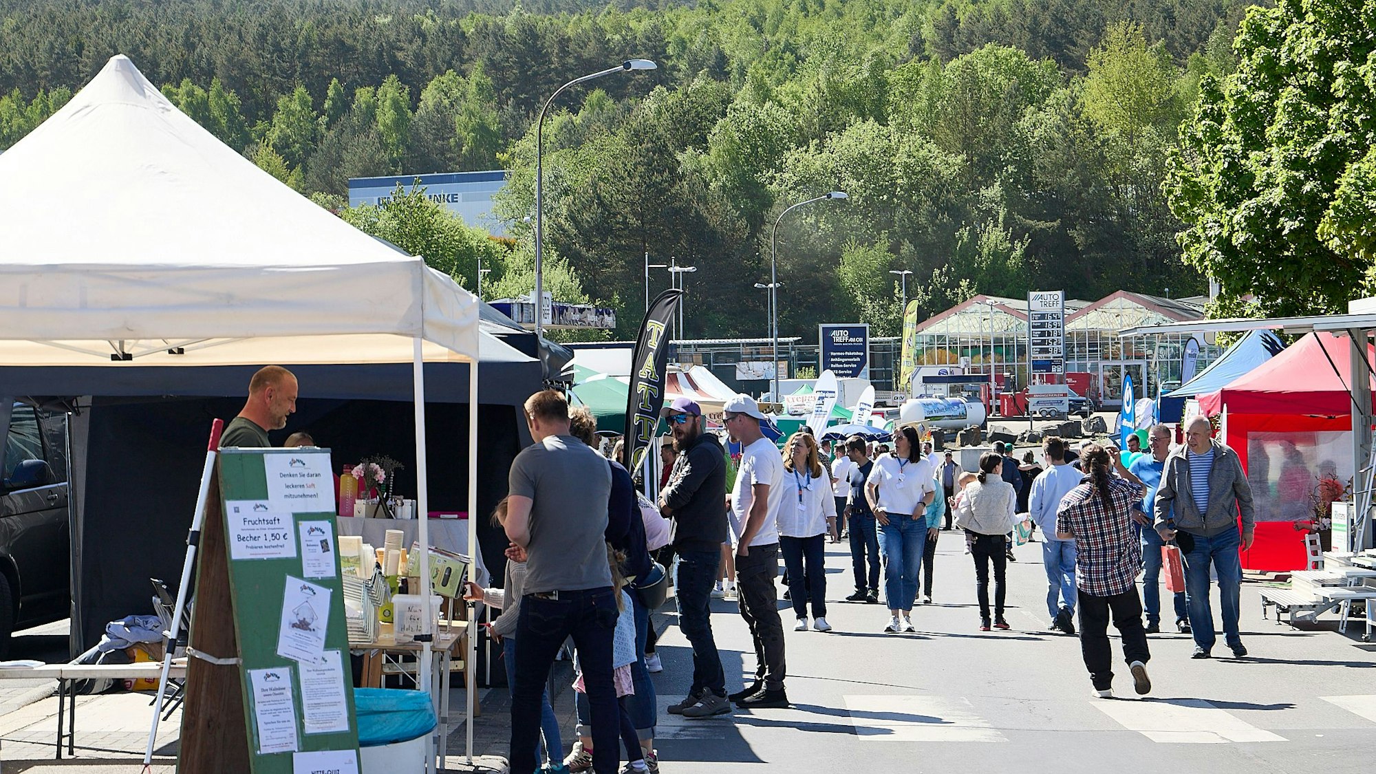 Das Bild zeigt mehrere Stände, vor denen Besucher stehen.