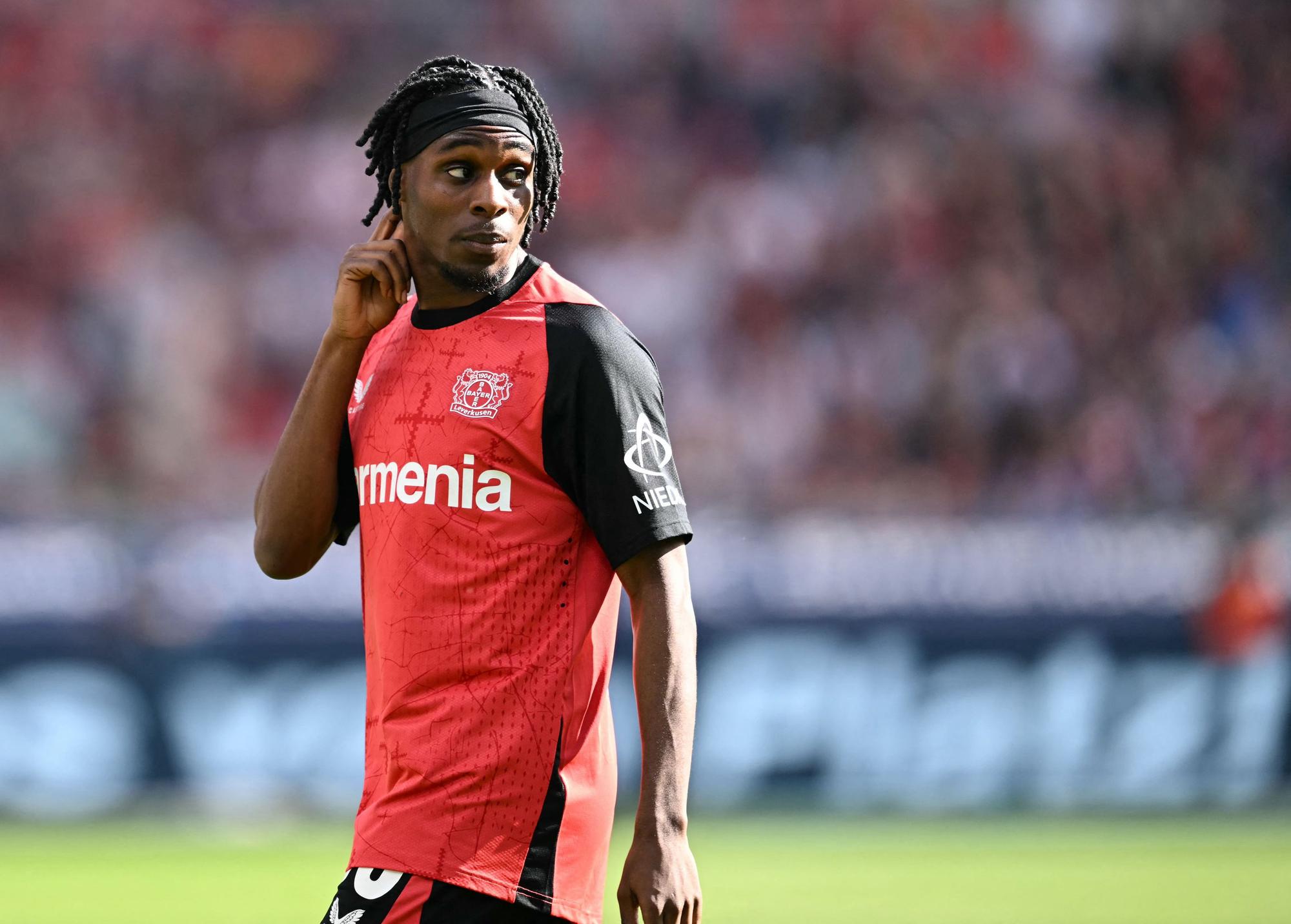 Bayer Leverkusen's Dutch defender #30 Jeremie Frimpong reacts during the German first division Bundesliga football match between Bayer Leverkusen and Union Berlin in Leverkusen, western Germany, on April 12, 2025. (Photo by INA FASSBENDER / AFP) / DFL REGULATIONS PROHIBIT ANY USE OF PHOTOGRAPHS AS IMAGE SEQUENCES AND/OR QUASI-VIDEO