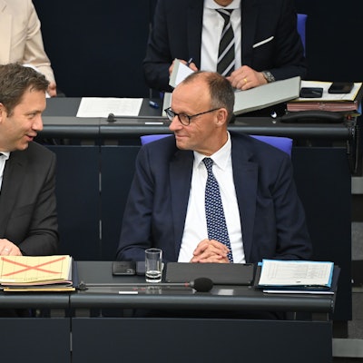 Bundeskanzler Friedrich Merz (CDU, r) und Lars Klingbeil (SPD), Bundesminister der Finanzen, unterhalten sich nach der Regierungserklärung im Plenum des Bundestags.