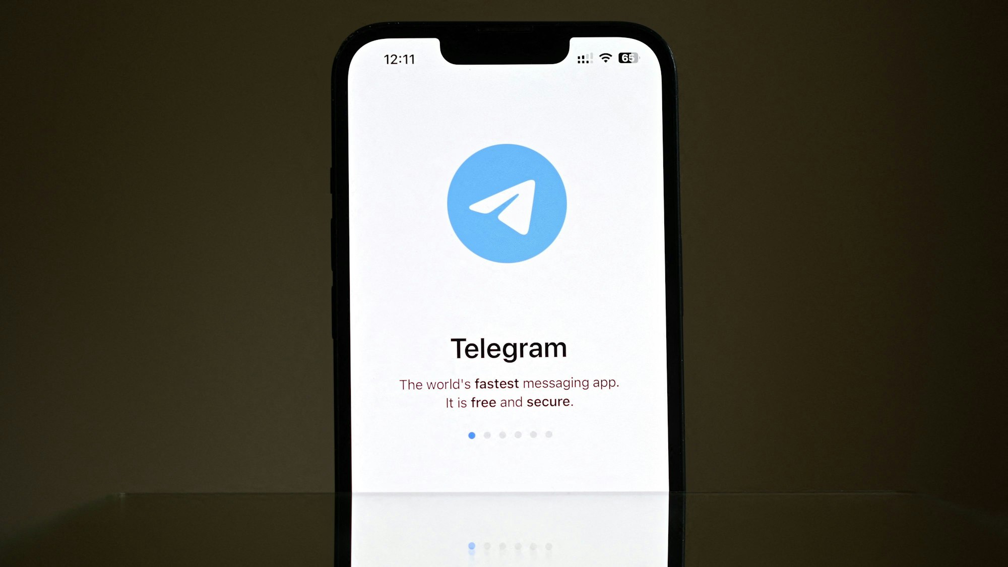 Ein Handydisplay ist zu sehen mit Telegram-Logo.