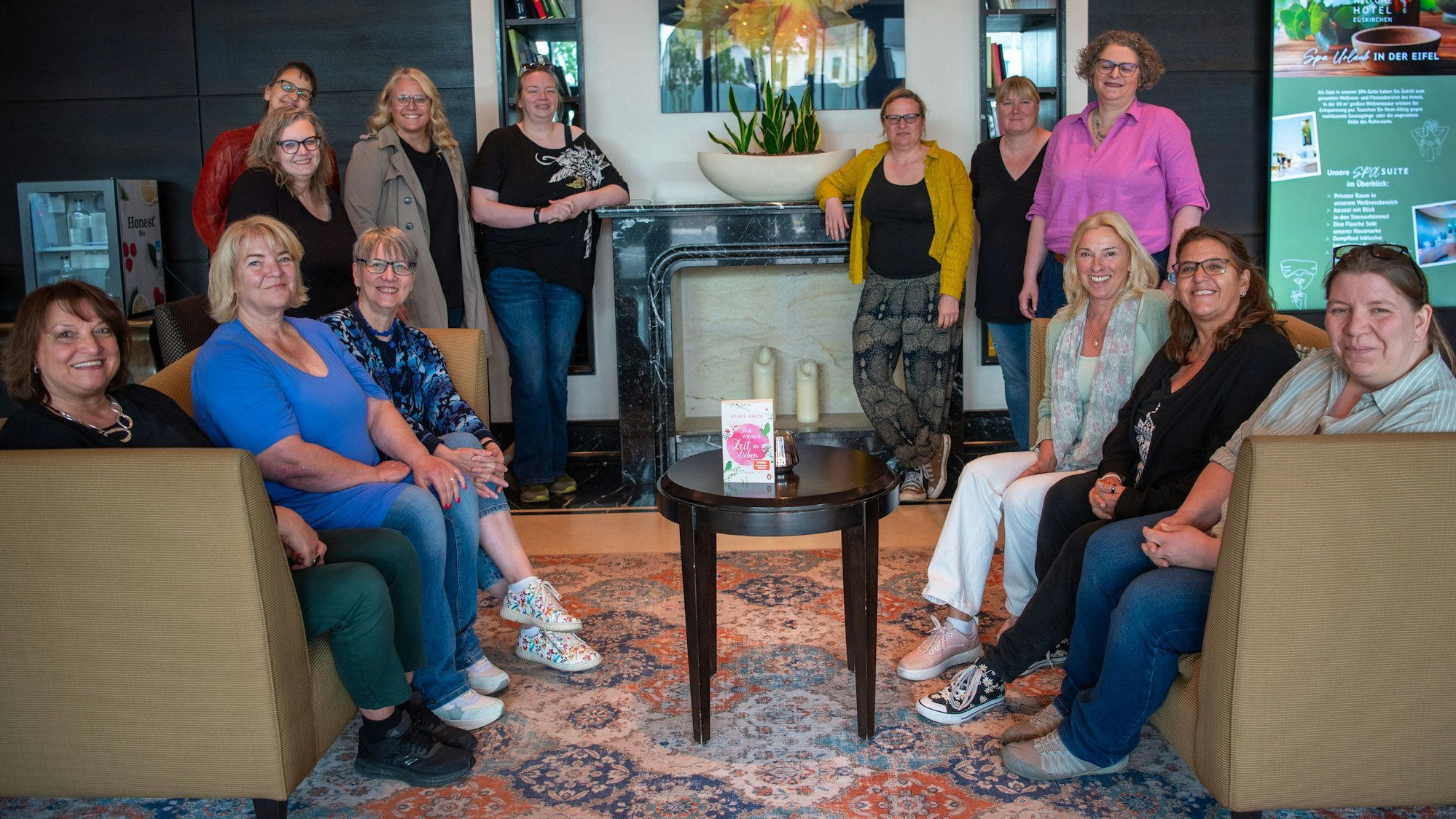Eine Gruppe Frauen sitzt im Foyer eines Hotels.