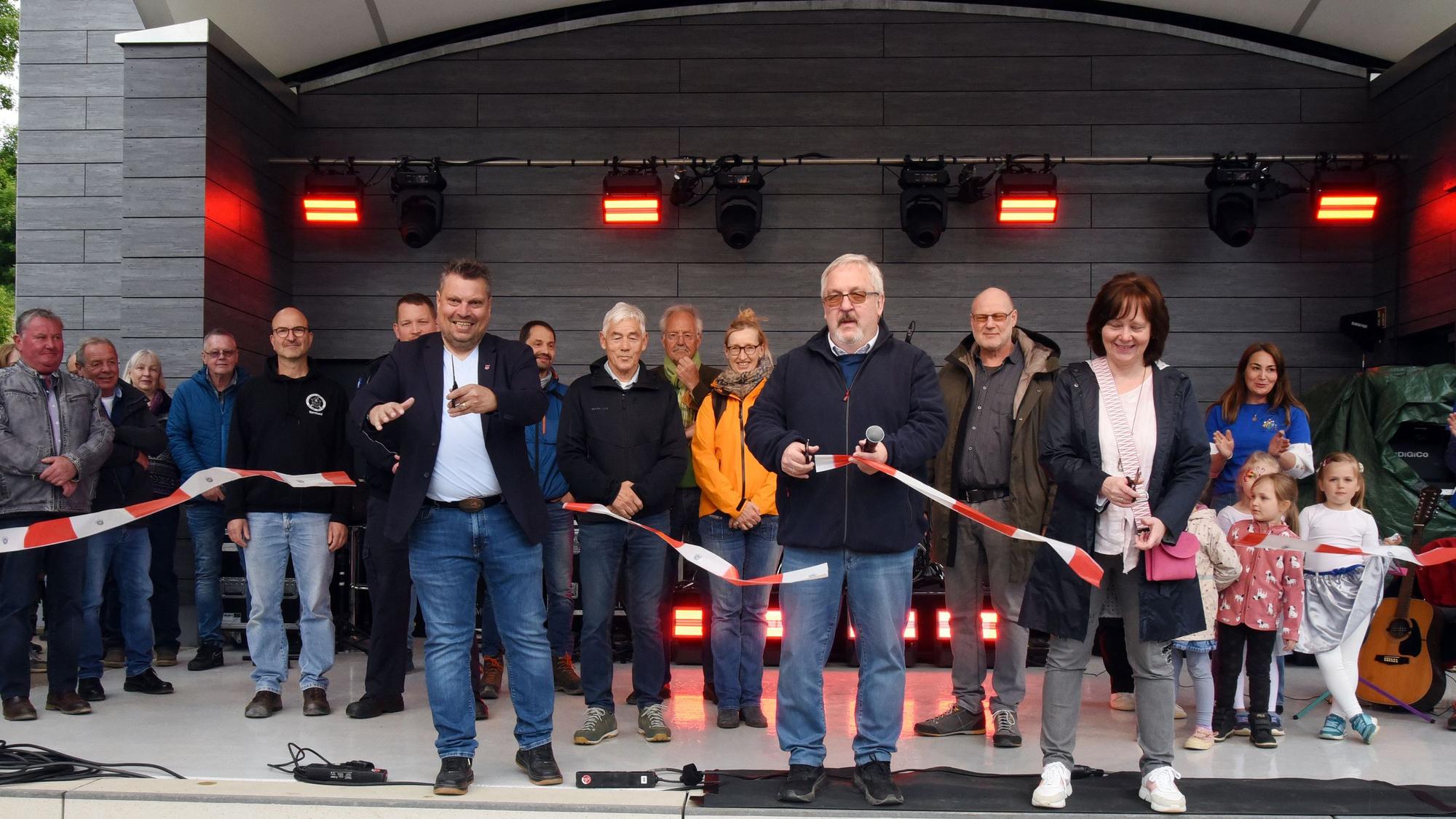 Bürgermeister Stefan Meisenberg (M.) und seine Stellvertreter Timo Fuchs (l.) und Birgit Meckel schnippeln das Band durch.