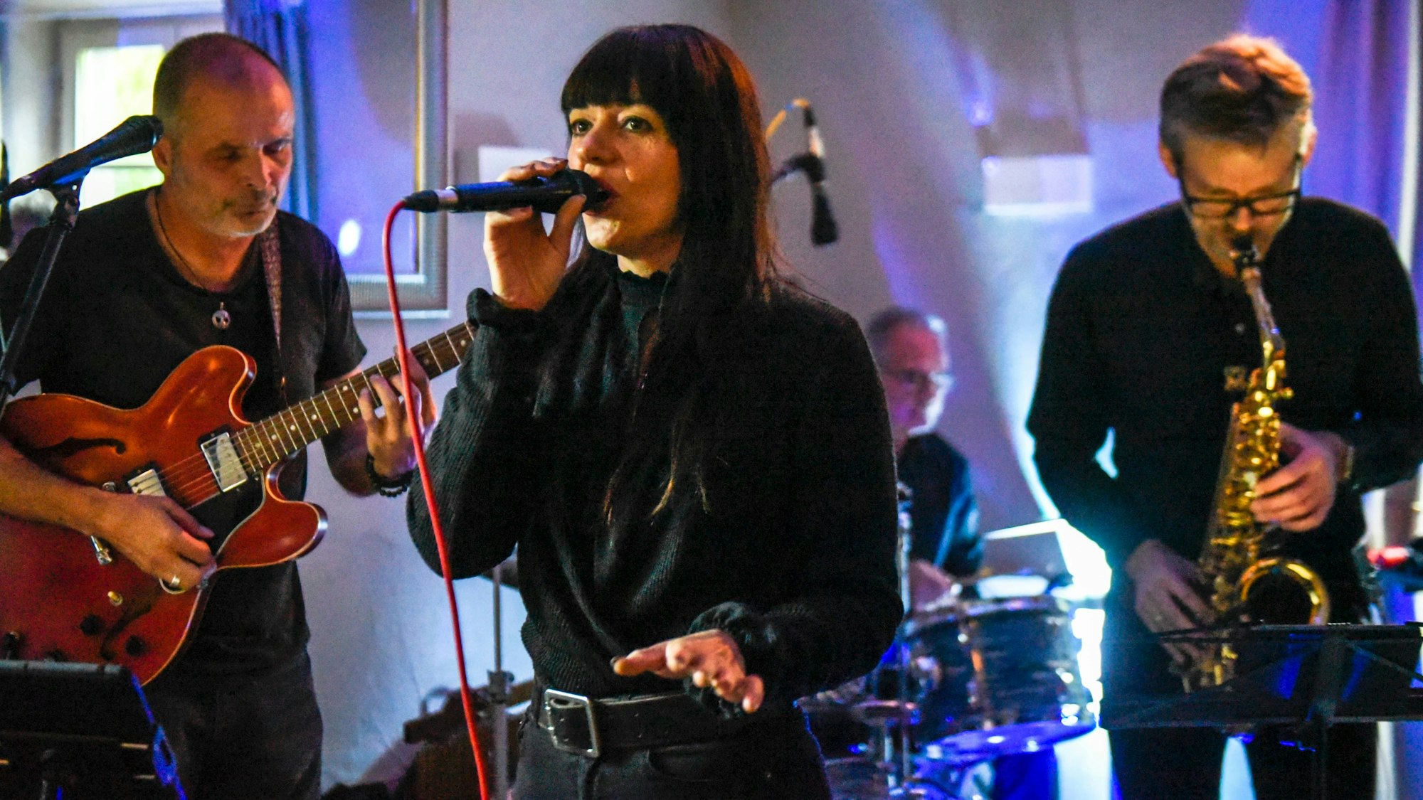 Zu sehen ist Sängerin Nina Anders mit ihrer Band beim Auftritt.