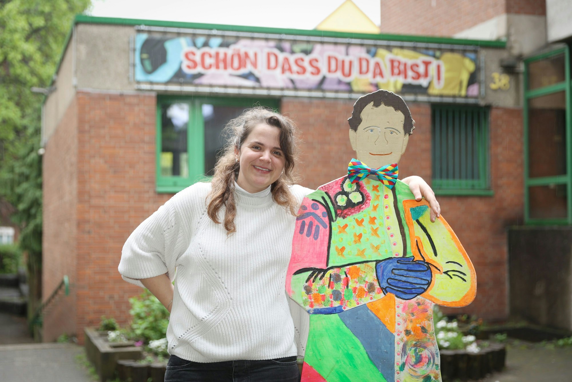 Die Leiterin des Don-Bosco-Clubs in Mülheim Magdalena Keil umarmt eine Pappfigur des Namensgebers der Jugendeinrichtung.