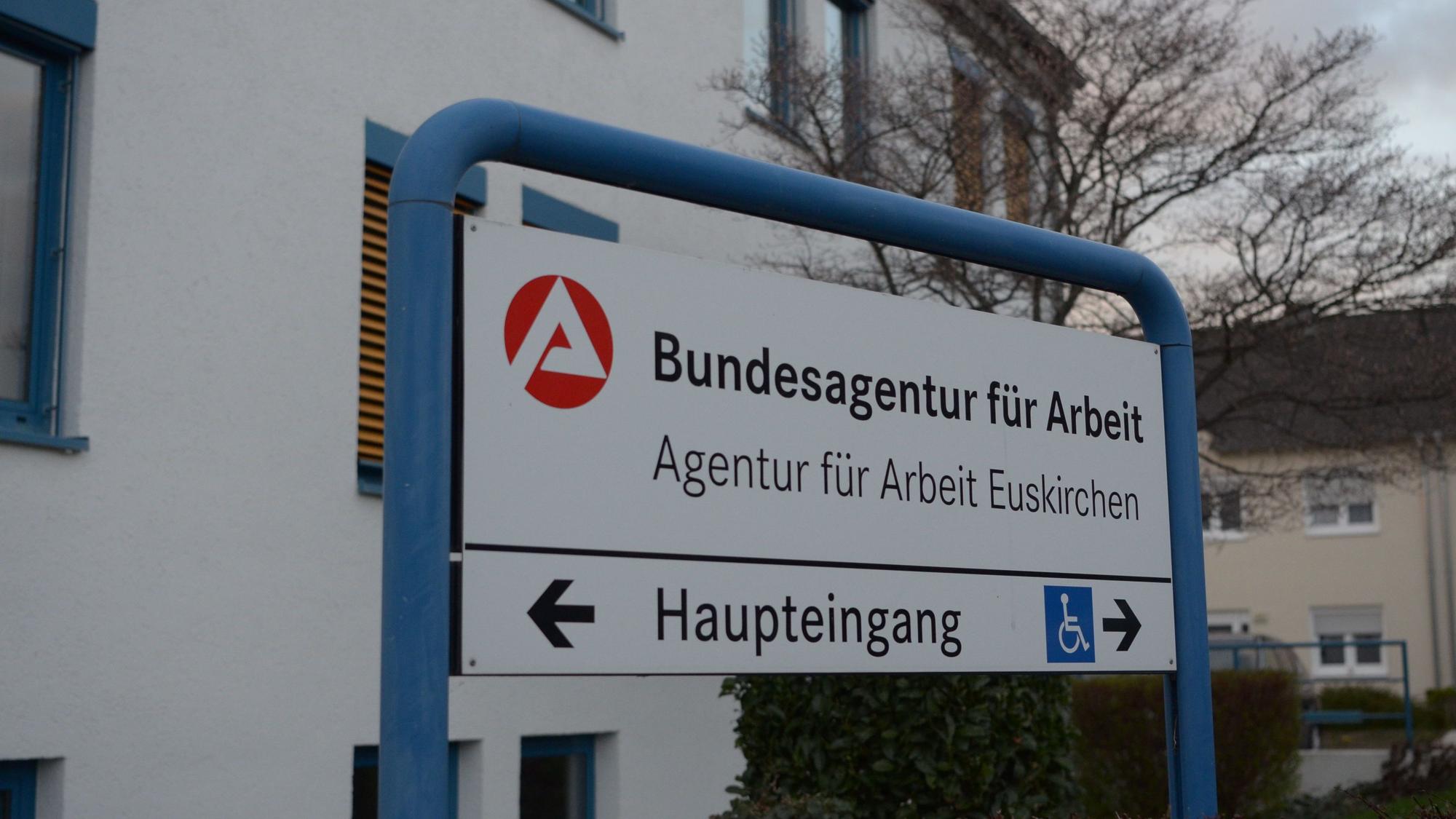 Vor dem Gebäude steht ein Schild mit der Aufschrift „Agentur für Arbeit Euskirchen“.