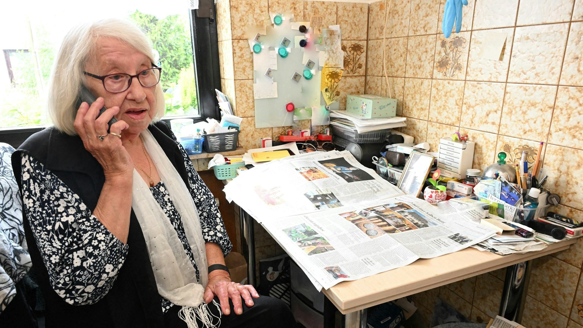 Die 86-jährige Gundula G. telefoniert an ihrem Schreibtisch.