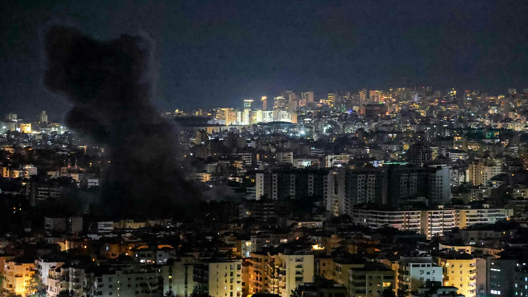 A smoke cloud rises from the site of an Israeli airstrike on Beiruts southern suburbs on June 5, 2025. Huge numbers of people fled Beirut's southern suburbs on June 5 after the Israeli military issued an evacuation warning and said it would strike underground drone factories belonging to Hezbollah. (Photo by IBRAHIM AMRO / AFP)