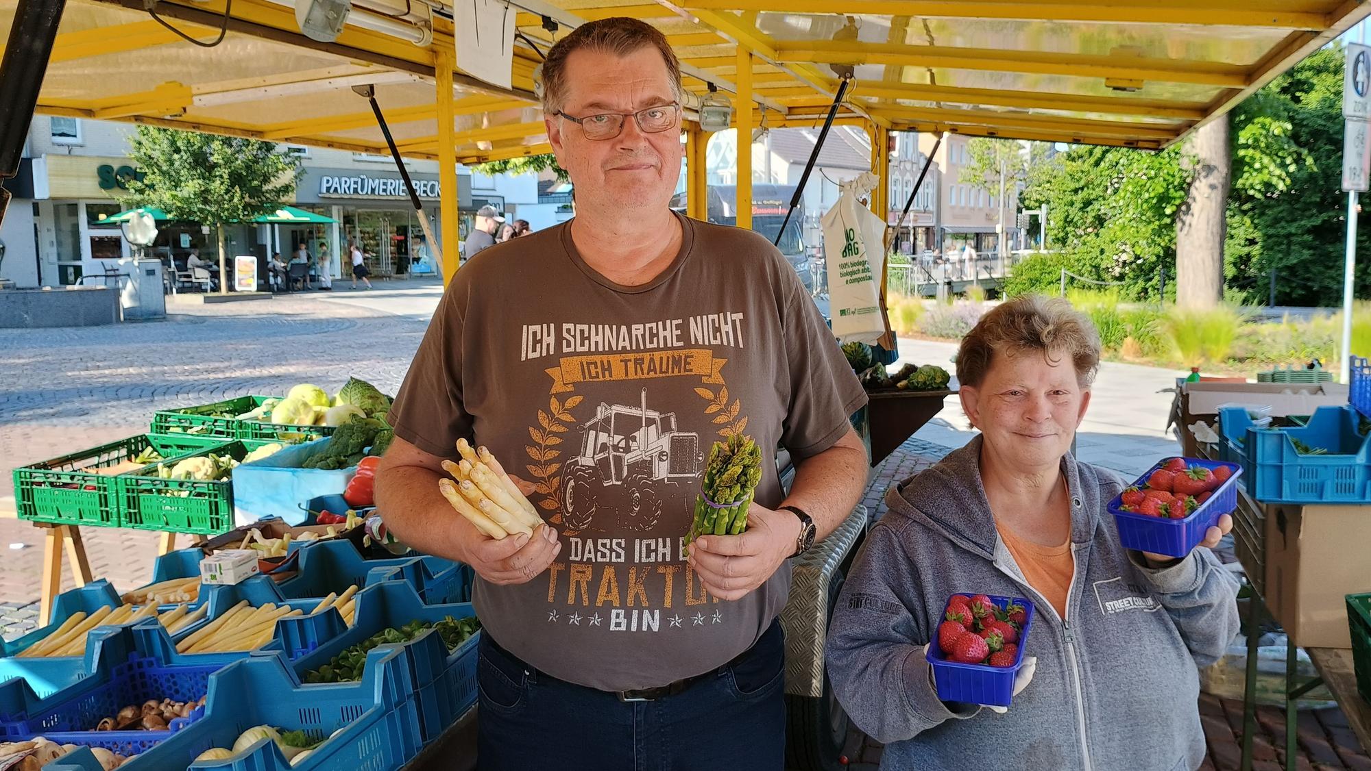 Gerd Hass hält auf dem Bild Spargel in der Hand, Carmen Odenthal zwei Schalen mit Erdbeeren.