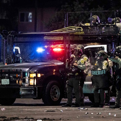 Sheriff deputies shoot at demonstrators with less lethal ammunitions during a protest following federal immigration operations, in the Compton neighborhood of Los Angeles, California on June 7, 2025. US President Donald Trump deployed 2,000 troops on June 7 to handle escalating protests against immigration enforcement raids in the Los Angeles area, a move the state's governor termed "purposefully inflammatory." Federal agents clashed with angry crowds in a Los Angeles suburb as protests stretched into a second night Saturday, shooting flash-bang grenades and shutting part of a freeway amid raids on undocumented migrants, reports said. (Photo by ETIENNE LAURENT / AFP)