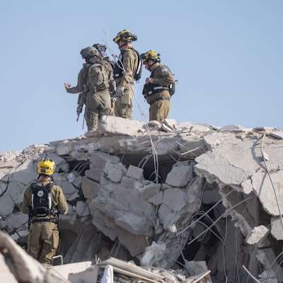 Rettungskräfte und israelische Soldaten begutachten die Schäden und suchen nach Opfern, nachdem eine iranische Rakete in Rishon Lezion eingeschlagen ist und dabei mindestens zwei Menschen getötet und mehrere weitere verletzt wurden.