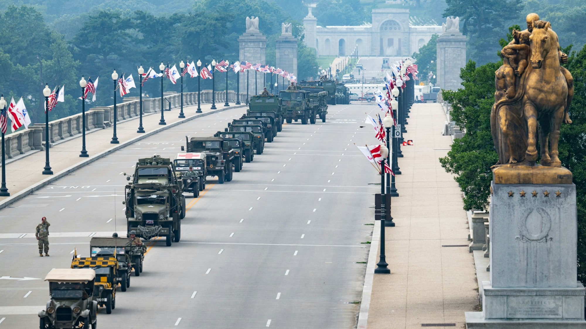 Members of the US Army and armored vehicle move across the Memorial Bridge during the Army 250th Anniversary Parade in Washington, DC, on June 14, 2025. US President Donald Trump reveled in a long dreamt-of military parade on his 79th birthday Saturday, as demonstrators across the country branded him a dictator in the biggest protests since his return to power. (Photo by Annabelle GORDON / AFP)