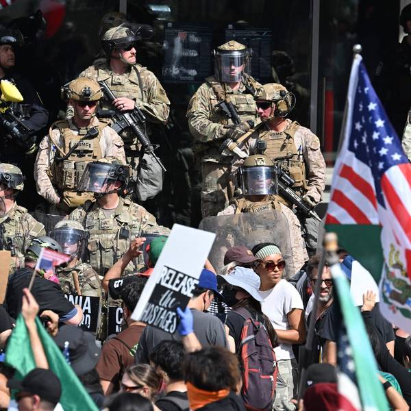 US Marines, California National Guard and Los Angeles Police stand guard on the steps of the Federal Building on June 14, 2025 in Los Angeles, as protesters participating in the "No Kings" demonstration arrived in the area. Tens of thousands of protesters rallied nationwide Saturday against Donald Trump ahead of a huge military parade on the US president's 79th birthday -- as the killing of a Democratic lawmaker underscored the deep divisions in American politics. "No Kings" demonstrators took to the streets in New York, Los Angeles, Chicago, Philadelphia, Houston, Atlanta and hundreds of other cities across the United States to condemn what they call Trump's dictatorial overreach. (Photo by Robyn Beck / AFP)