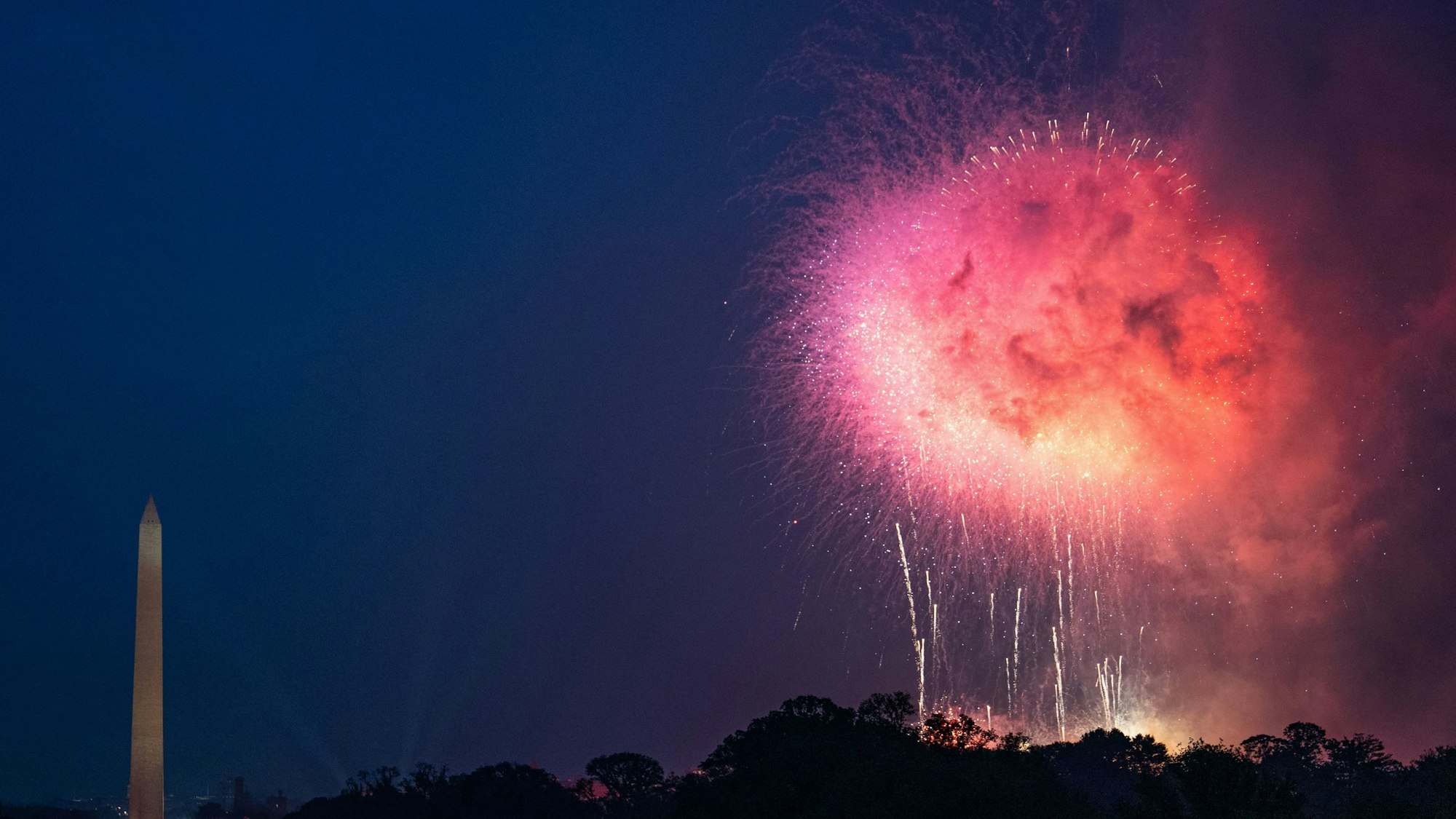 Fireworks light up the sky and the Washington Monument at the conclusion of the Army 250th Anniversary Parade in Washington, DC on June 14, 2025. US President Donald Trump reveled in a long dreamt-of military parade on his 79th birthday Saturday, as demonstrators across the country branded him a dictator in the biggest protests since his return to power. (Photo by Annabelle GORDON / AFP)
