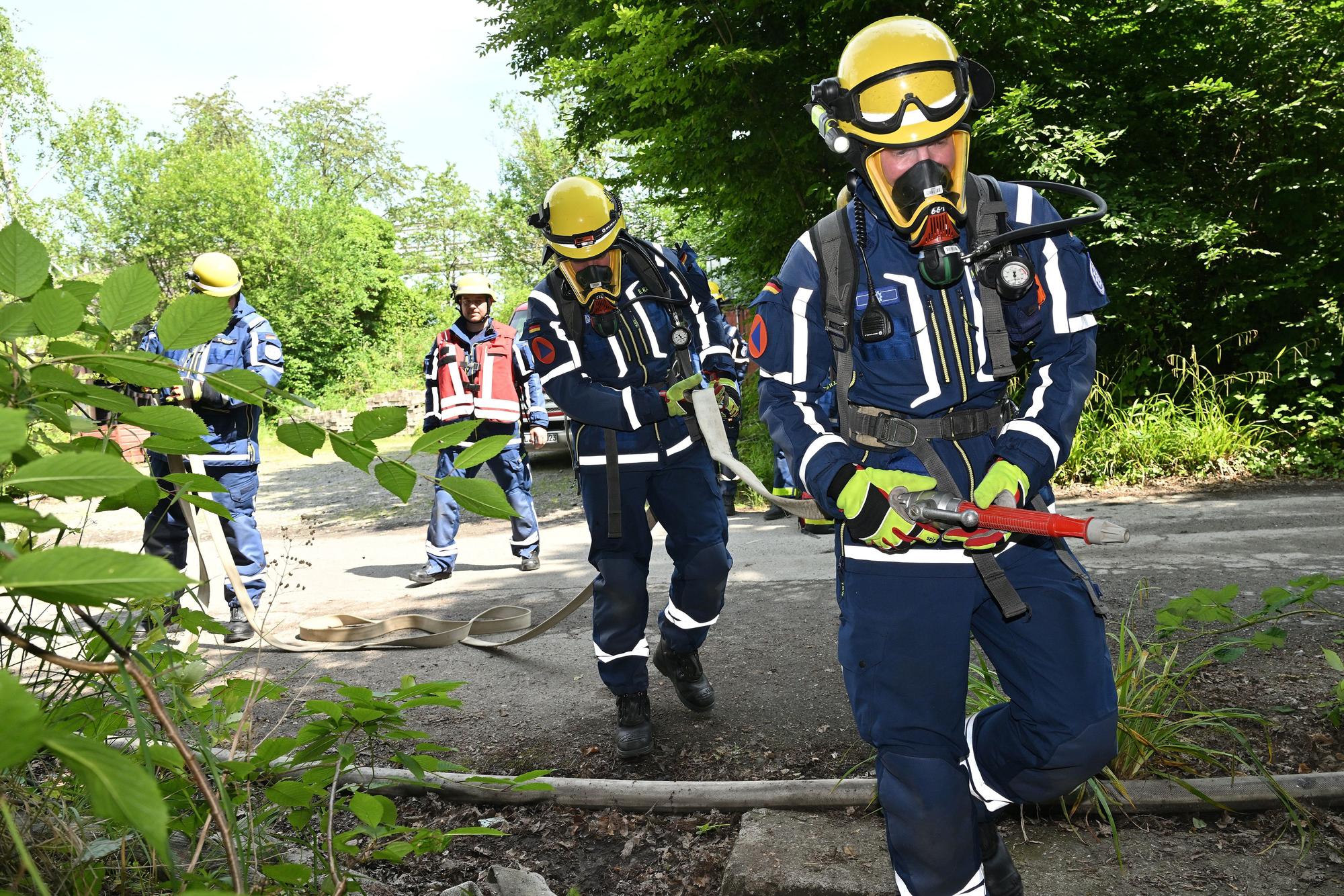 Ein Trupp von THWlern startet bei der Großübung der Feuerwehr Bergisch Gladbach einen Löschangriff.