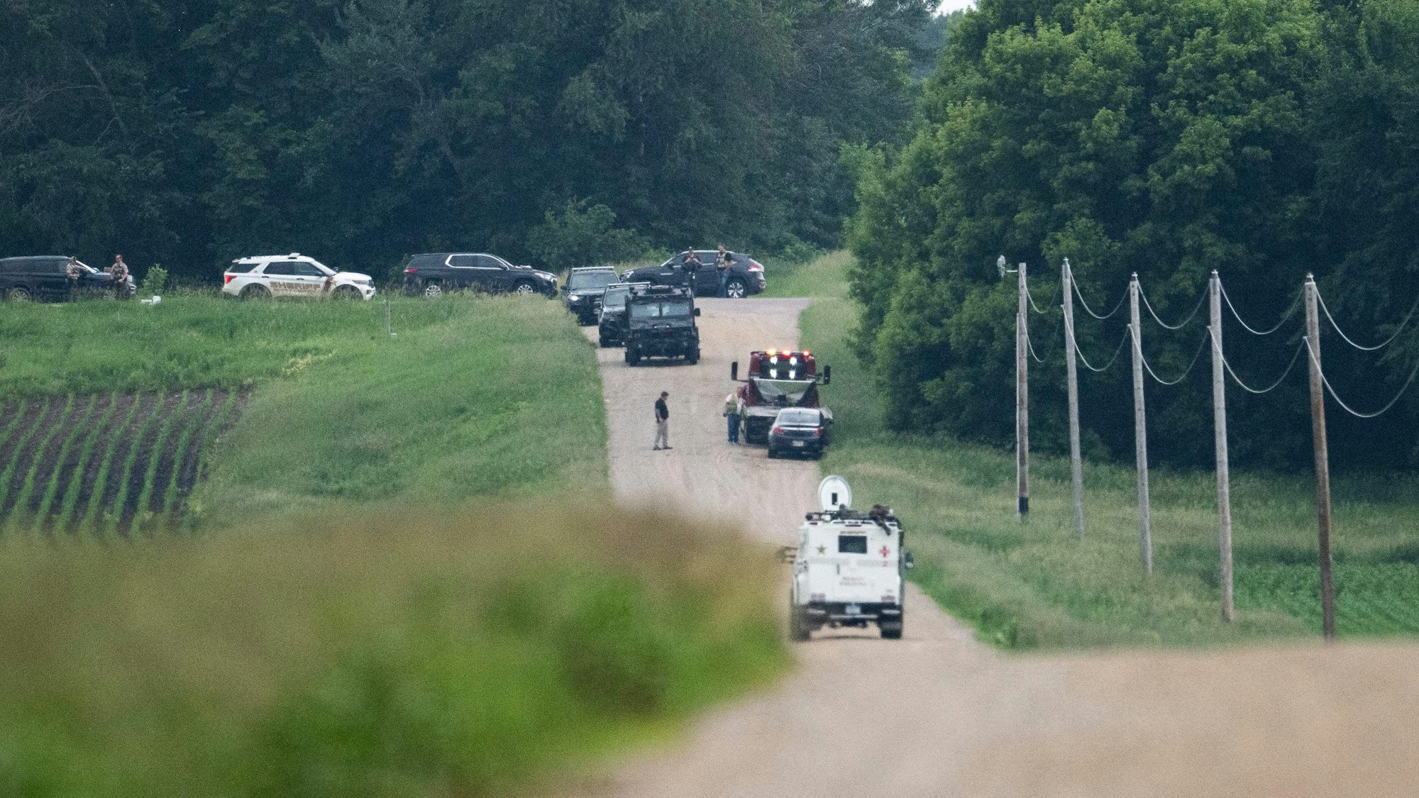 BELLE PLAINE, MINNESOTA - JUNE 15: A tow truck removes a vehicle as law enforcement searches the area on 301st Avenue on June 15, 2025 in Belle Plaine, Minnesota. Law enforcement agencies are searching for Vance Boelter, a suspect in the killing of DFL State Rep. Melissa Hortman and her husband, Mark Hortman, who were shot at their home yesterday. DFL State Sen. John Hoffman and his wife were also shot and hospitalized in a separate incident. Minnesota Gov. Tim Walz said during a press conference that the shooting "appears to be a politically motivated assassination." Stephen Maturen/Getty Images/AFP (Photo by Stephen Maturen / GETTY IMAGES NORTH AMERICA / Getty Images via AFP)