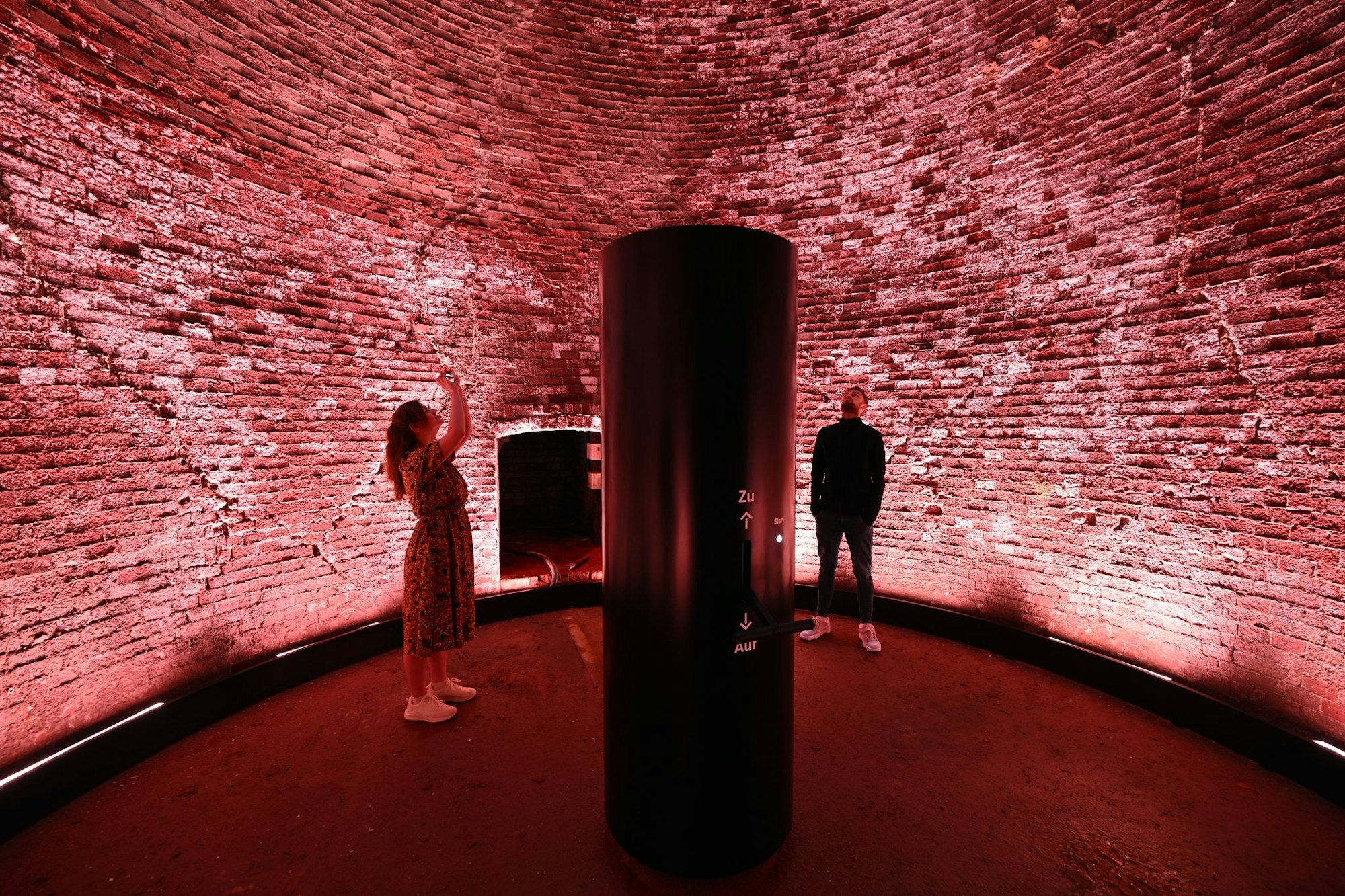 Höllenmaschine mit Lichtkunst: Der 98 Meter hohe Schornstein der Kokerei Zollverein leuchtet rot als Teil des erweiterten Denkmalpfads.
