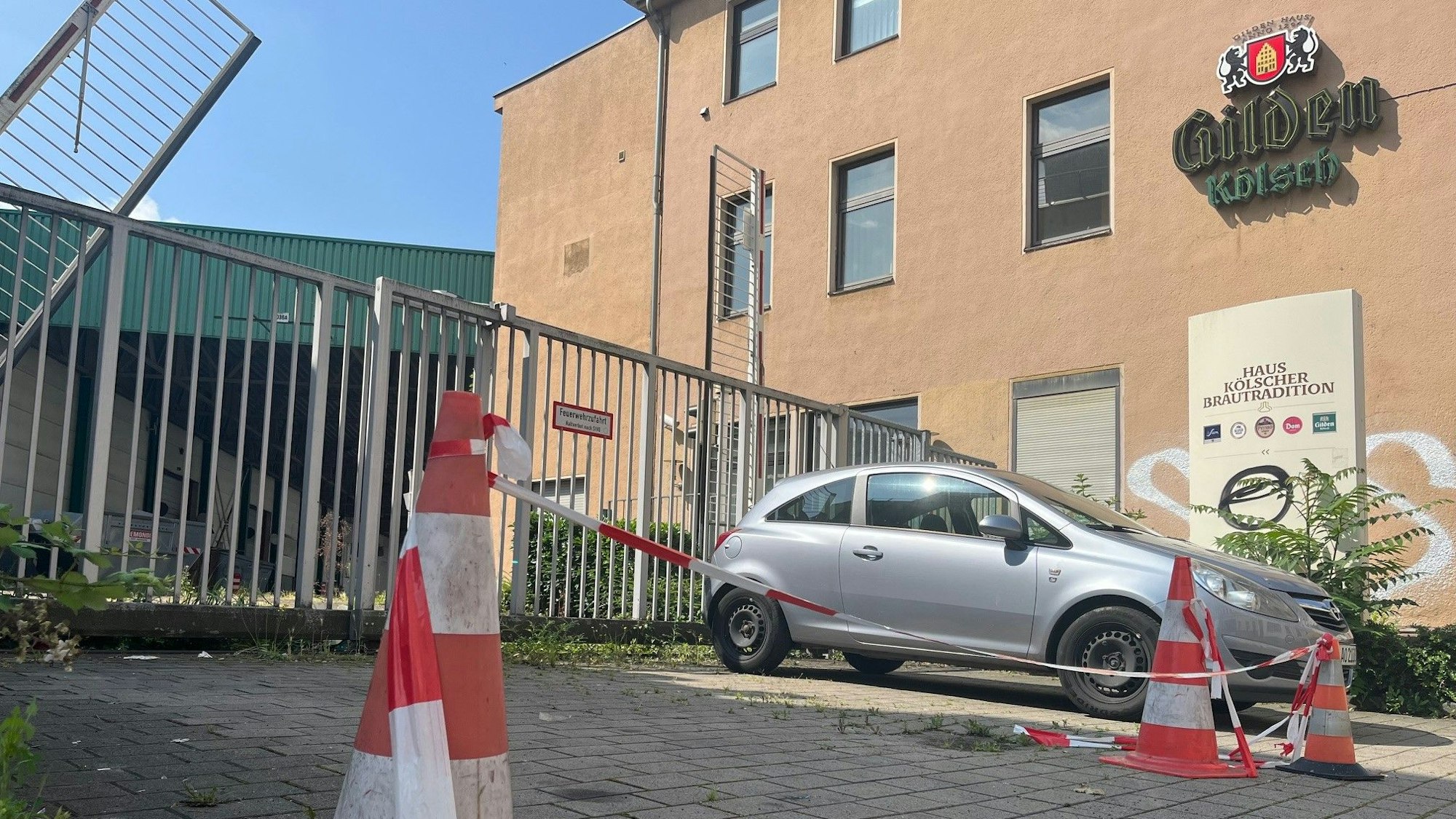 Absperrband vor einem Firmentor.