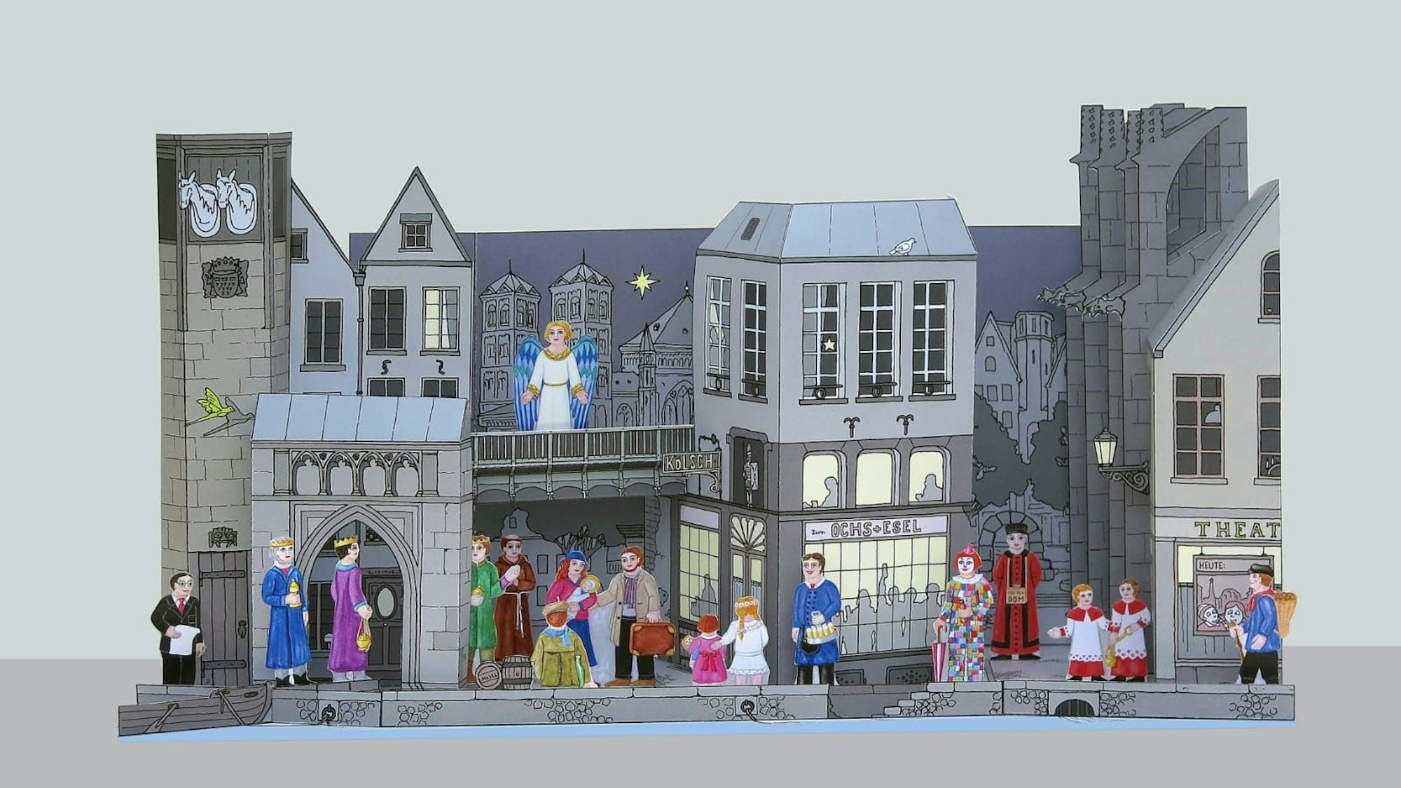 Eine Papierkrippe zeigt verschiedene Motive der Stadt Köln.