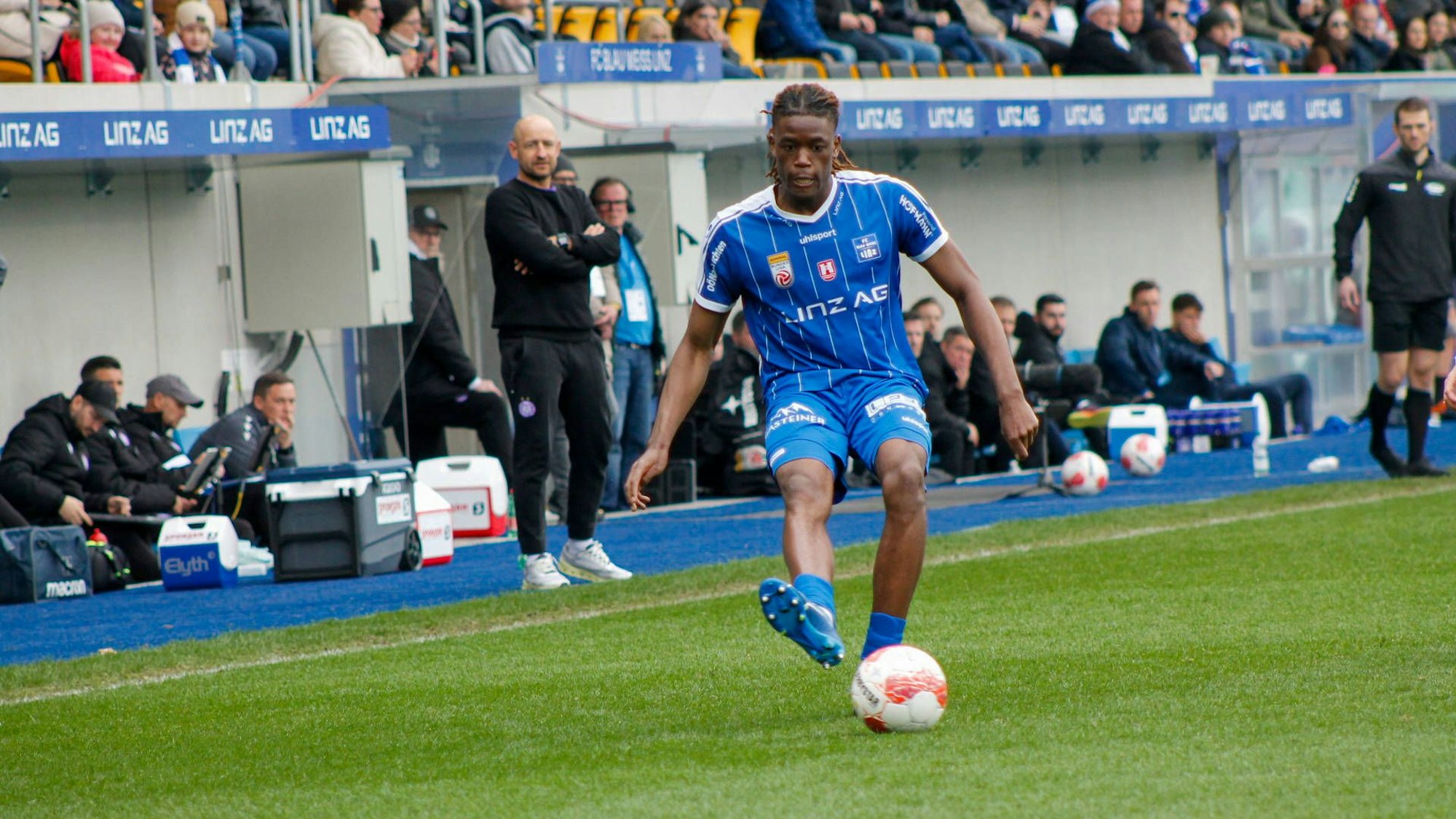 Elias Bakatukanda bei seinem Leih-Klub Blau-Weiß Linz auf dem Rasen.
