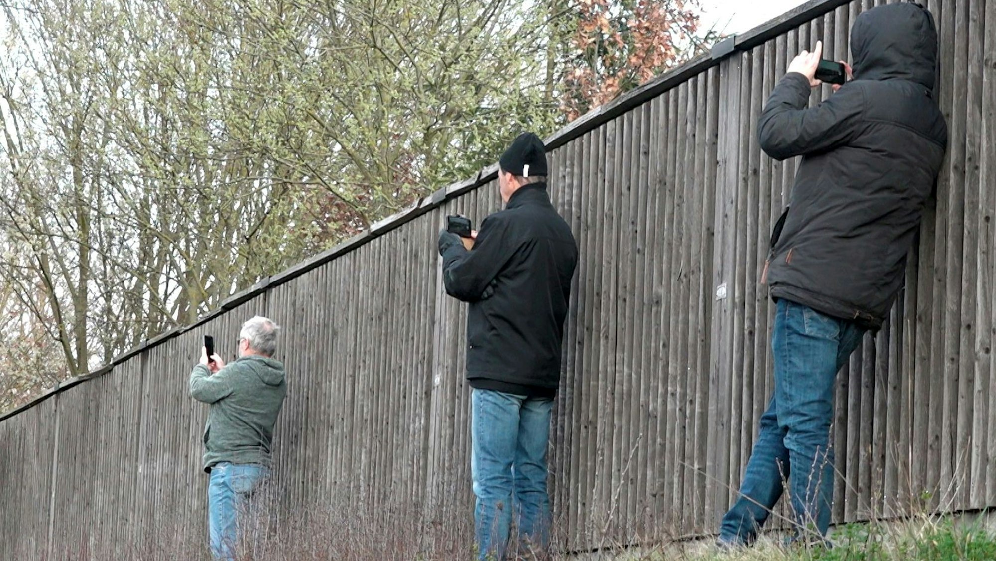 Schaulustige fotografieren eine Unfallstelle auf einer Autobahn in Bayern.