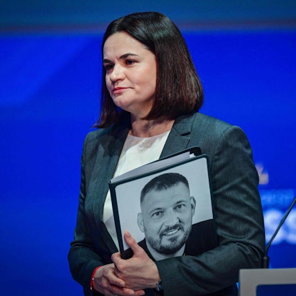 Oppositionspolitikerin Swetlana Tichanowskaja 2024 mit einem Bild ihres damals noch inhaftierten Mannes.