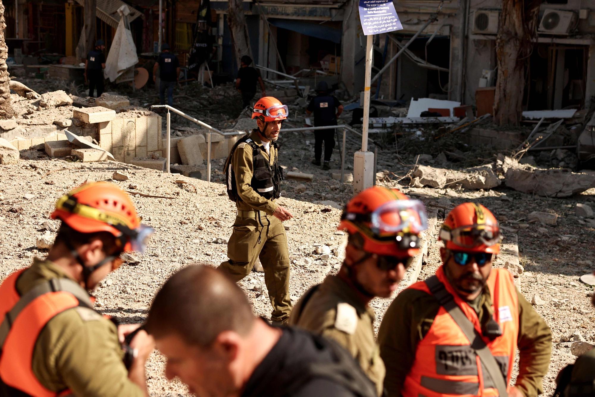 Israeli first responders inspect the damage at the site of an Iranian strike that hit a residential area in the port city of Haifa on June 22, 2025. President Donald Trump said the US military had carried out strikes early on June 22 on three Iranian nuclear sites and that Tehran "must now agree to end this war", following days of speculation over whether the United States would join its ally Israel's bombing campaign. (Photo by Fadel SENNA / AFP)