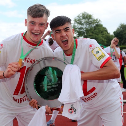 DORTMUND, GERMANY - JUNE 16: (L-R) Florian Wirtz abnd Jens Castrop of Koeln celebrate with the German Championship trohphy after the B-Juniors Bundesliga Final match between Borussia Dortmund and 1. FC Koeln at Stadium Rote Erde on June 16, 2019 in Dortmund, Germany. The match between Dortmund and Koeln ended 2-3.  (Photo by Christof Koepsel/Bongarts/Getty Images)