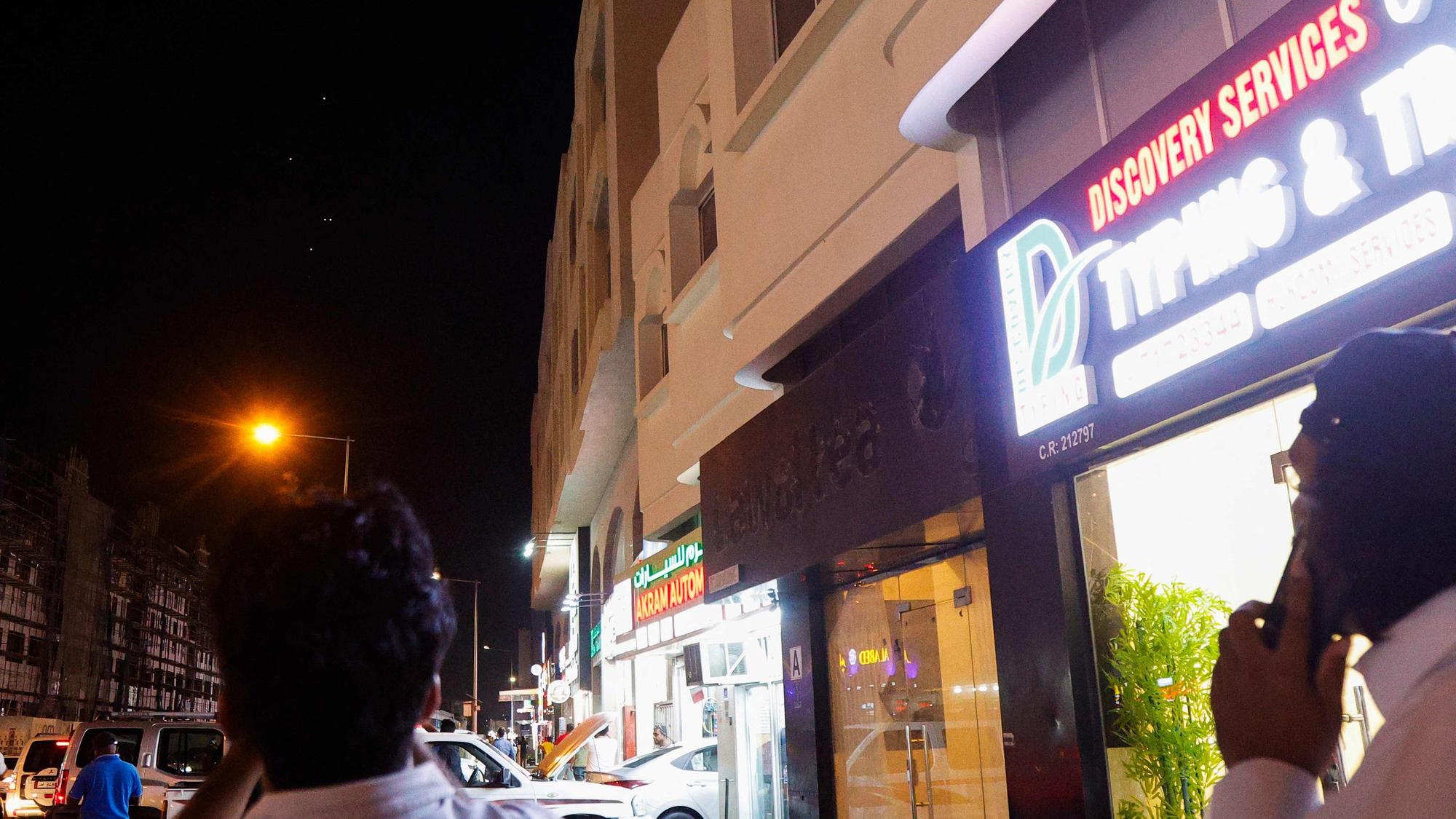 People film projectiles over Doha in Qatar on June 23, 2025. Qatar on June 23, 2025 condemned an Iranian attack on the largest US military base in the region, hosted in the Gulf state, calling it a "flagrant violation" of its sovereignty". (Photo by AFP)